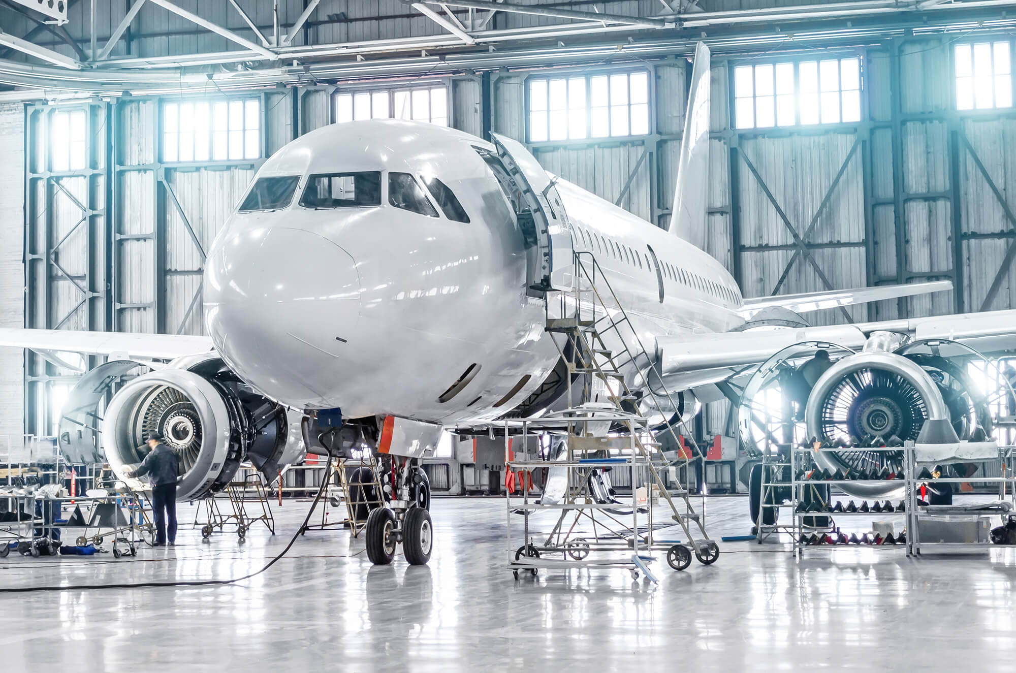 Passenger aircraft on maintenance of engine and fuselage repair in airport hangar